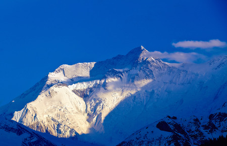 beautifull cloudy sunrise in the mountains with snow ridgeの写真素材