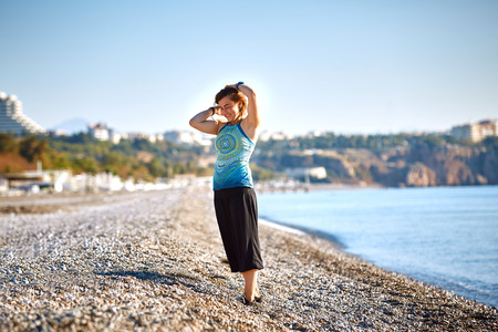 girl plays on the sea beach at the early morningの写真素材