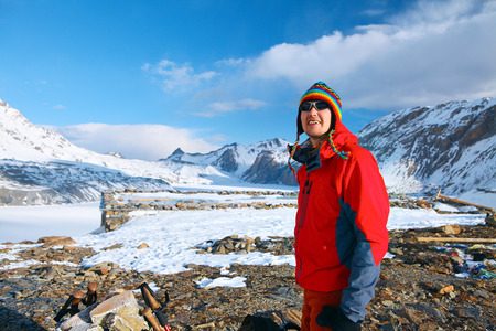 hiker at the top of a pass with backpacks meeting the sunrise in the mountainsの写真素材