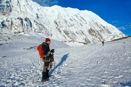 Hiking photographer taking pictures. Trek around Annapurna mount.の写真素材