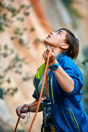 female belayer with the rope looking outside of cameraの写真素材