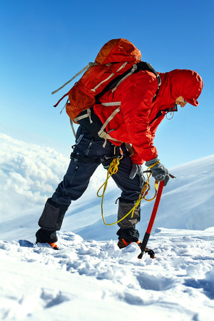 hiker at the top of a pass with backpacks meeting the sunrise in the mountainsの写真素材