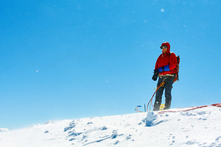 hiker at the top of a pass with backpacks meeting the sunrise in the mountainsの写真素材