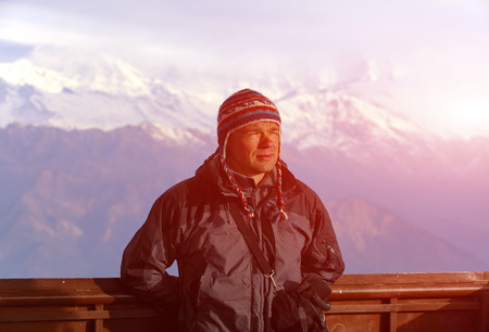 hiker at the top of a pass meeting the sunrise in the mountainsの写真素材