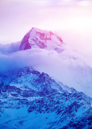 beautifull cloudy sunrise in the mountains with snow ridge. Trek around Annapurna mount. Himalaya, Nepal.の写真素材