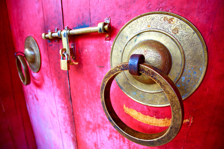 iron knocker and latch on an old door of a monasteryの写真素材