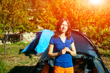 young woman near the tent at the morning in the garden. Turkey, Geyikbayiri.の写真素材