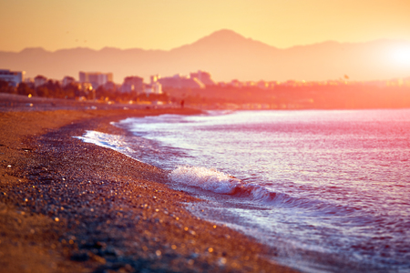 beach with wave and pebbles at the sunrise. Antalya, Turkeyの写真素材