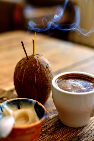 Cup of coffee, dried fruits and honey on a wooden background. small depth of fieldの写真素材