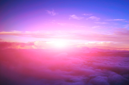 view colored clouds from an airplane at dawnの写真素材