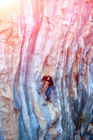rock climber climbs on a rocky wallの写真素材