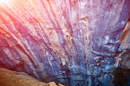 rock climber climbs on a rocky wallの写真素材
