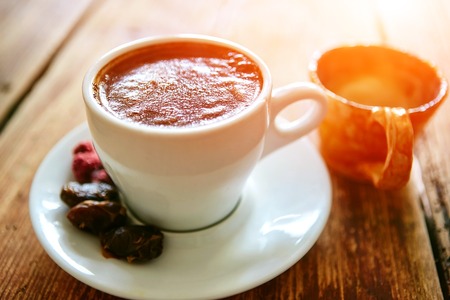 Cup of coffee, dried fruits and honey on a wooden background. small depth of fieldの写真素材