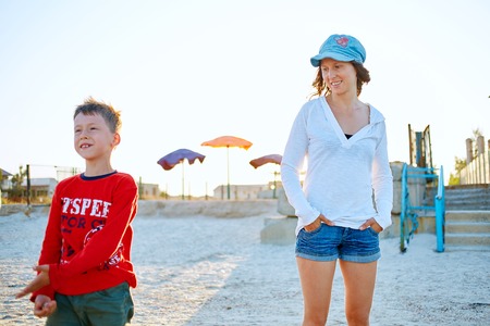 family on the beach at the  sunsetの写真素材