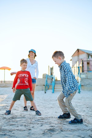 family on the beach at the  sunsetの写真素材