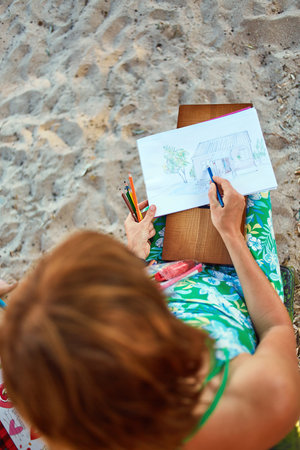 woman with sketch pen drawing in outdoorの写真素材