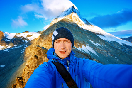 hiker  at the top of a pass  making selfie against  the Matterhorn mount, Switzerlandの写真素材