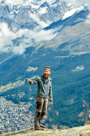hiker at the top of a pass with backpack enjoy sunny day in Alps. Switzerland, Trek near Matterhorn mount.の写真素材