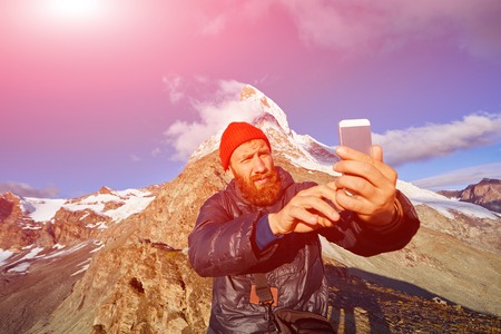 hiker  at the top of a pass  making selfie against  the Matterhorn mount, Switzerlandの写真素材