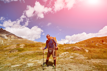 hiker with backpack on the trail in the Apls mountains. Trek near Matterhorn mountの写真素材
