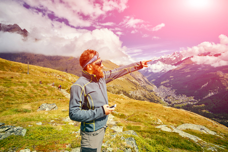 hiker at the top of a pass with backpack enjoy sunny day in Alps. Switzerland, Trek near Matterhorn mount.の写真素材