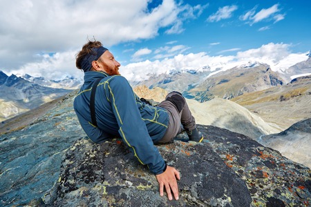 hiker at the top of a pass have a rest at sunny day in Alps. Switzerland, Trek near Matterhorn mount.の写真素材