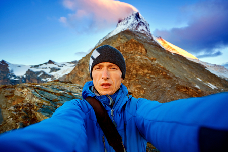 hiker  at the top of a pass  making selfie against  the Matterhorn mount, Switzerlandの写真素材
