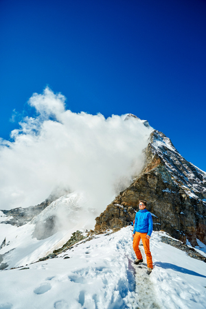 hiker under the mount enjoy sunny day in Alps. Switzerland, Trek near Matterhorn mount.の写真素材