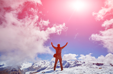 hiker at the top of a pass with backpack enjoy sunny day in Alps. Switzerland, Trek near Matterhorn mount.の写真素材
