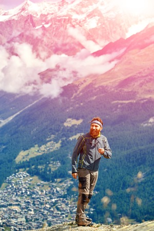 hiker at the top of a pass with backpack enjoy sunny day in Alps. Switzerland, Trek near Matterhorn mount.の写真素材