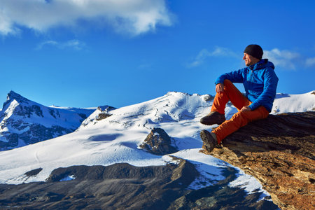 hiker at the top of a pass with backpack enjoy sunny day in Alps. Switzerland, Trek near Matterhorn mount.の写真素材