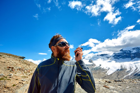 hiker at the top of a pass with radio enjoy sunny day in Alps. Switzerland, Trek near Matterhorn...