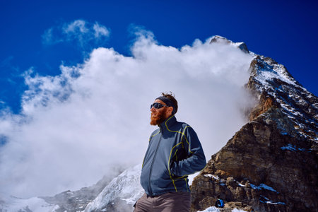 hiker at the top of a pass with backpack enjoy sunny day in Alps. Switzerland, Trek near Matterhorn mount.の写真素材
