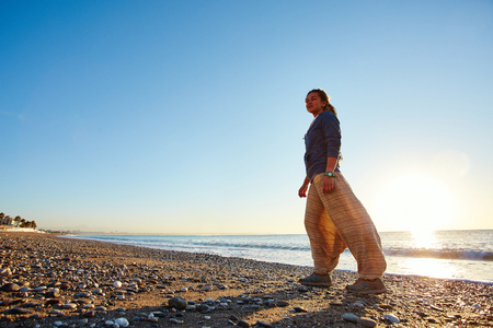 young happy girl with dreads walking on the beach. Turkey, Antalya.の写真素材
