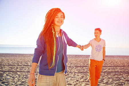 young happy couple running on the beach. focus on woman. Turkey, Antalya.の写真素材