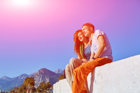 young happy couple  sitting on the beach.の写真素材