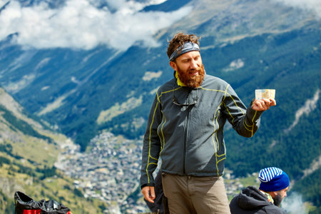 hiker at the top of a pass  enjoy sunny day in Alps. Switzerland, Trek near Matterhorn mount.の写真素材