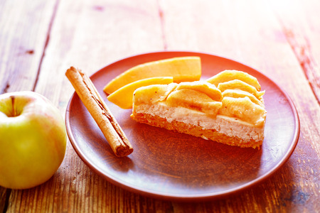 Dietary homemade cakes on a wooden background. sponge cake with cheese mousse, cinnamon and pumpkinの写真素材