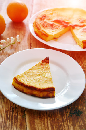 Dietary homemade cheesecake on a plate on a wooden background.の写真素材