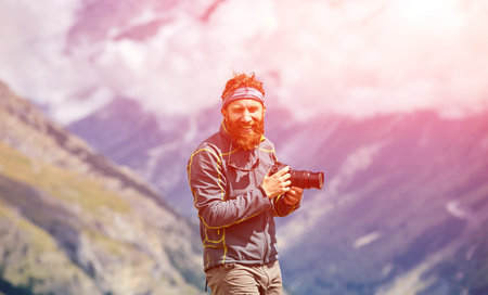 hiker at the top of a pass with camera enjoy sunny day in Alps. Switzerland, Trek near Matterhorn mount.の写真素材