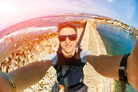 young man make selfie on the beachの写真素材