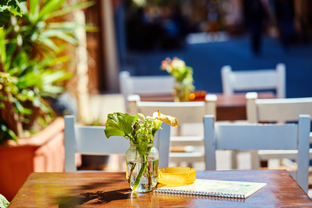 Empty tables of street cafes at sunny noonの写真素材