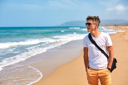 man on the empty sunny beach, Crete, Greeceの写真素材