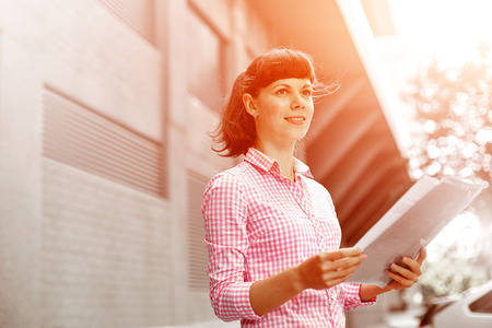 young woman with phone standing outdoor. Lifestyle or business conceptの写真素材