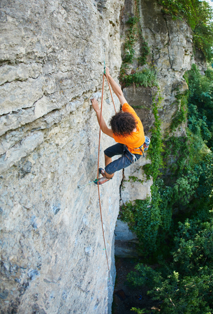 male rock climber. rock climber climbs on a rocky wallの写真素材