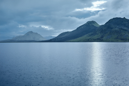 Lake coast with mountain reflection at the sunrise, Icelandの写真素材