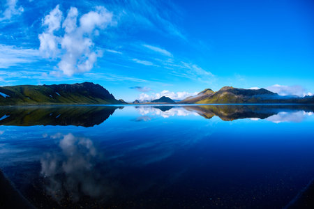 Lake coast with mountain reflection at the sunrise, Icelandの写真素材