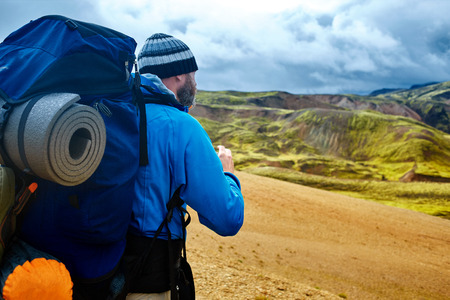man hiker on the trail in the Islandic mountains. Trek in National Park Landmannalaugar, Icelandの写真素材