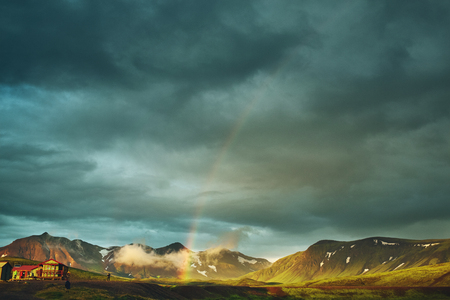 Travel to Iceland. Beautiful sunset in camping near Alftavatn lake. Icelandic landscape with mountains, sky and clouds. Trekking in national park Landmannalaugar. Rainy Evening with big rainbow.の写真素材