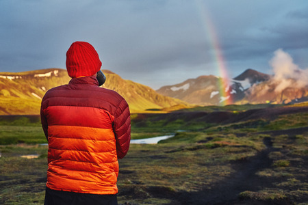 Travel to Iceland. Beautiful sunset in camping near Alftavatn lake. Icelandic landscape with mountains, sky and clouds. Trekking in national park Landmannalaugar. Rainy Evening with big rainbow.の写真素材